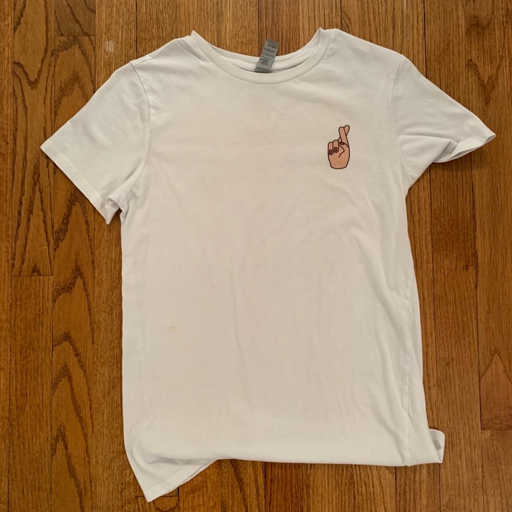 White tshirt with fingers crossed